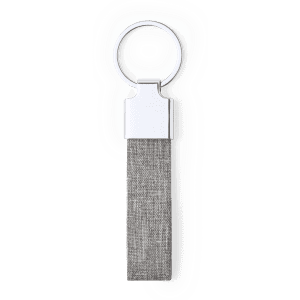 A grey fabric keyring featuring a silver metal ring and a sleek design. It includes a logo on the metal part.