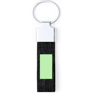 A keyring with a silver metal loop and a black fabric strap featuring a green rectangular section.