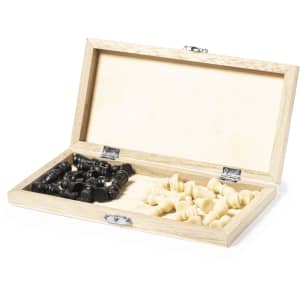 A wooden chess set with black and cream pieces housed in an open box, featuring a plain interior and a logo.