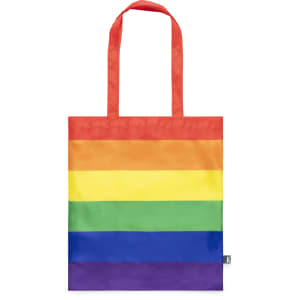 A reusable grocery bag featuring vibrant rainbow stripes with red handles and a small logo.