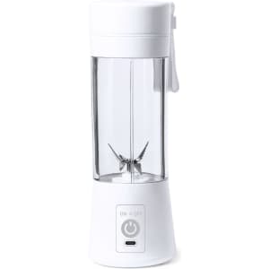 A white portable blender with a clear container and a power button at the base, featuring sharp metal blades inside.