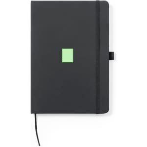 A black notepad featuring a green square design. It includes an elastic band and a ribbon bookmark.