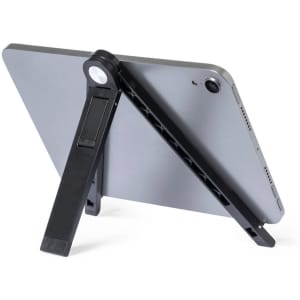 A black phone stand is positioned behind a grey tablet, displaying its adjustable feature. The stand has a branding logo on it.