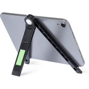 A black phone stand with a green accent, holding a tablet in a vertical position. It has a logo visible.