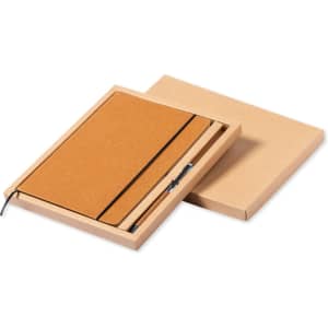 A brown notebook set in a natural box, featuring an elastic band and a pen. The box has a simple design and shape.