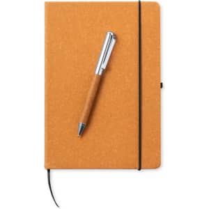 An orange notebook with a sleek design, featuring a black elastic band and a brown pen on top.