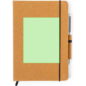 A brown notebook with a green blank area on the front, featuring an elastic band and a pen attached.