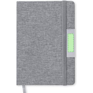 A grey notebook with a textured cover and a green tab. It features an elastic closure and a ribbon bookmark.