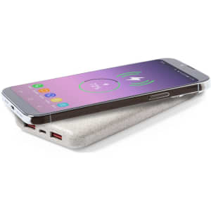 A power bank in a light grey finish, with a smartphone on top, displaying a charging indicator. It features multiple ports and a logo.