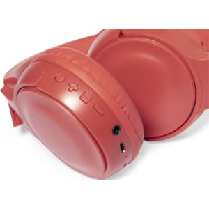 A pair of coral red headphones featuring control buttons and a charging port. The design includes a logo.