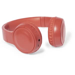 A pair of coral red headphones with a smooth design, featuring buttons and a port for connectivity.