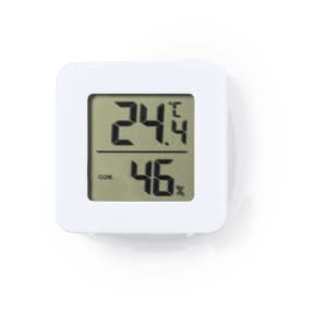 A white electronic weather station displaying temperature and humidity readings. It features a digital screen and simple design.