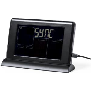 A black weather station with a digital display, featuring connectivity icons and a charging port.