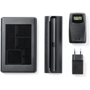A black weather station kit featuring a main unit, sensor, and charger, all in a sleek design.
