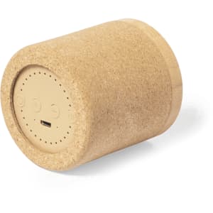 A cylindrical speaker in a natural cork finish, featuring a logo and a USB charging port on the bottom.