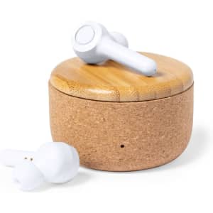 White earbuds sit beside a round case made of cork and bamboo, showcasing a natural and minimalist design.