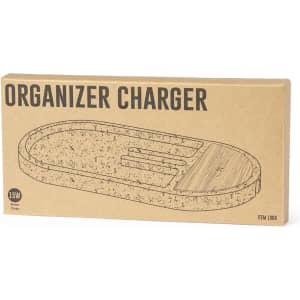 A wireless charger in an oval shape with a natural wood finish, presented in a cardboard box featuring a logo.