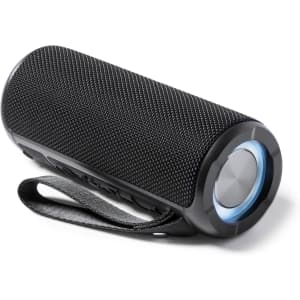 A portable black speaker with a textured design, featuring a blue illuminated button and a fabric strap for carrying.