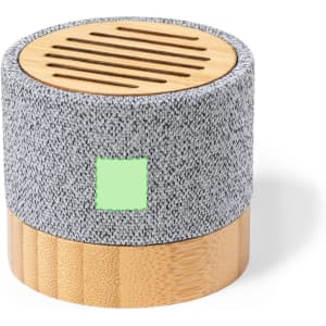 A round speaker with a grey fabric exterior and a bamboo base featuring slotted ventilation on top.