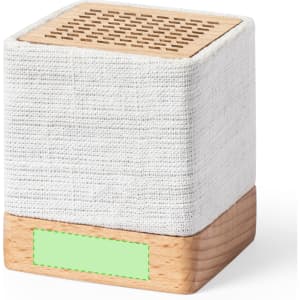 A square speaker with a textured white fabric exterior and a wooden base, featuring a patterned top.