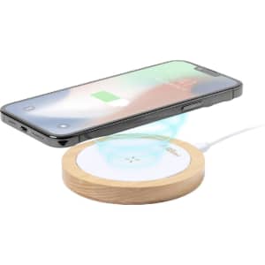 A wireless charger with a wooden base, paired with a smartphone displaying a charging icon.