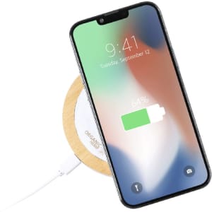 A wireless charger with a wooden base, featuring a smartphone displaying a 64% battery charge.