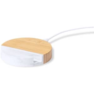 A wireless charger holder featuring a bamboo top and a white bottom, connected by a white cable.