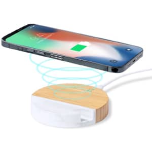 A wireless charger holder featuring a wooden base and a white underside, with a smartphone charging above it.