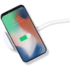 A wireless charger holder in white with a smartphone displaying a charging battery icon. The charger has a cable connected.