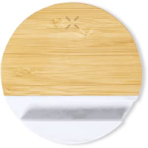 A round bamboo charger holder featuring a white base. It has a logo in the centre.