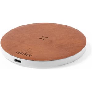 A wireless charger with a round shape, featuring a brown leather surface and a white base. It has a logo.