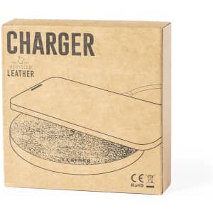 A square, cardboard box containing a wireless charger with a recycled leather surface, featuring a simple design.