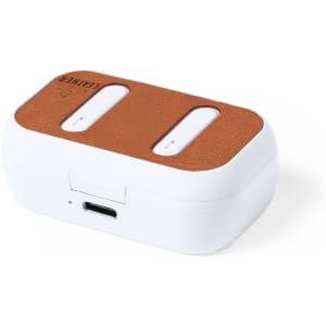A pair of white earphones in a charging case with a brown faux leather top and a USB-C port.