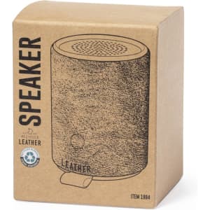 A cylindrical speaker made from recycled leather, presented in a brown cardboard box with a simple design.
