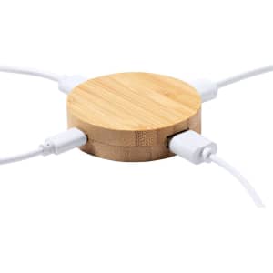 A round bamboo USB hub with multiple white cables connected, featuring a simple and natural design.