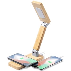 A multifunction alarm clock in natural wood finish, featuring a foldable design and wireless charging for two phones.