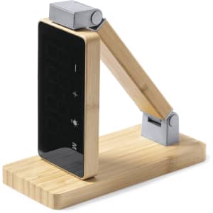 A multifunction alarm clock with a sleek black display, bamboo structure, and silver accents.