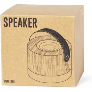 A brown cardboard box featuring an illustration of a wooden speaker with a handle. Includes a branding logo.