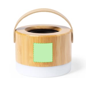 A round bamboo speaker with a white base and a carrying handle, featuring a green accent area.