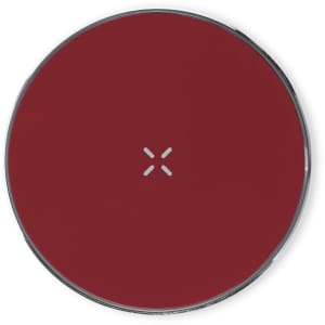A wireless charger in a deep red colour with a sleek round design and a metallic edge. It features a logo on the surface.