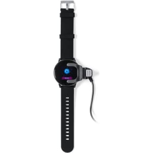 A black smart watch with a round face and adjustable strap, connected to a charging cable.