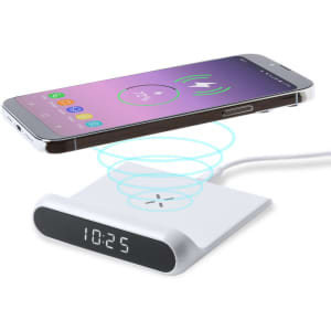 A white multifunction alarm clock with a wireless charger, featuring a digital display and a smartphone in charging position.