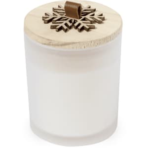 A white aromatic candle with a wooden lid featuring a snowflake design, perfect for home décor.