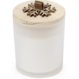 A frosted glass candle with a wooden lid featuring a snowflake design. The candle is white in colour.