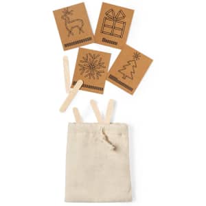 A beige drawstring bag containing wooden sticks and decorative cards with holiday-themed designs in brown.