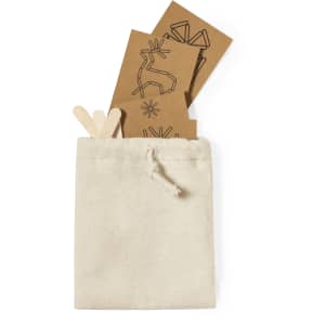 A cream drawstring pouch containing several brown cards with geometric designs and two wooden sticks.