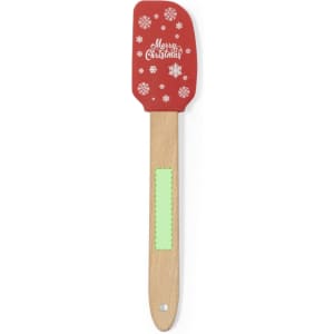 A red spatula with a wooden handle, featuring a festive design and a green section on the handle.