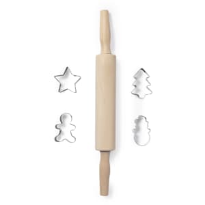 A wooden rolling pin with metal cookie cutters in star, tree, gingerbread man, and snowman shapes.