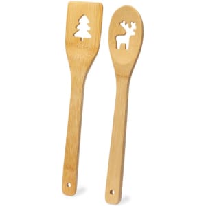 A wooden kitchen set featuring a spatula and spoon with cut-out designs of a tree and a reindeer.