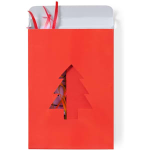 A red gift box with a cut-out Christmas tree design, adorned with colourful ribbons inside.